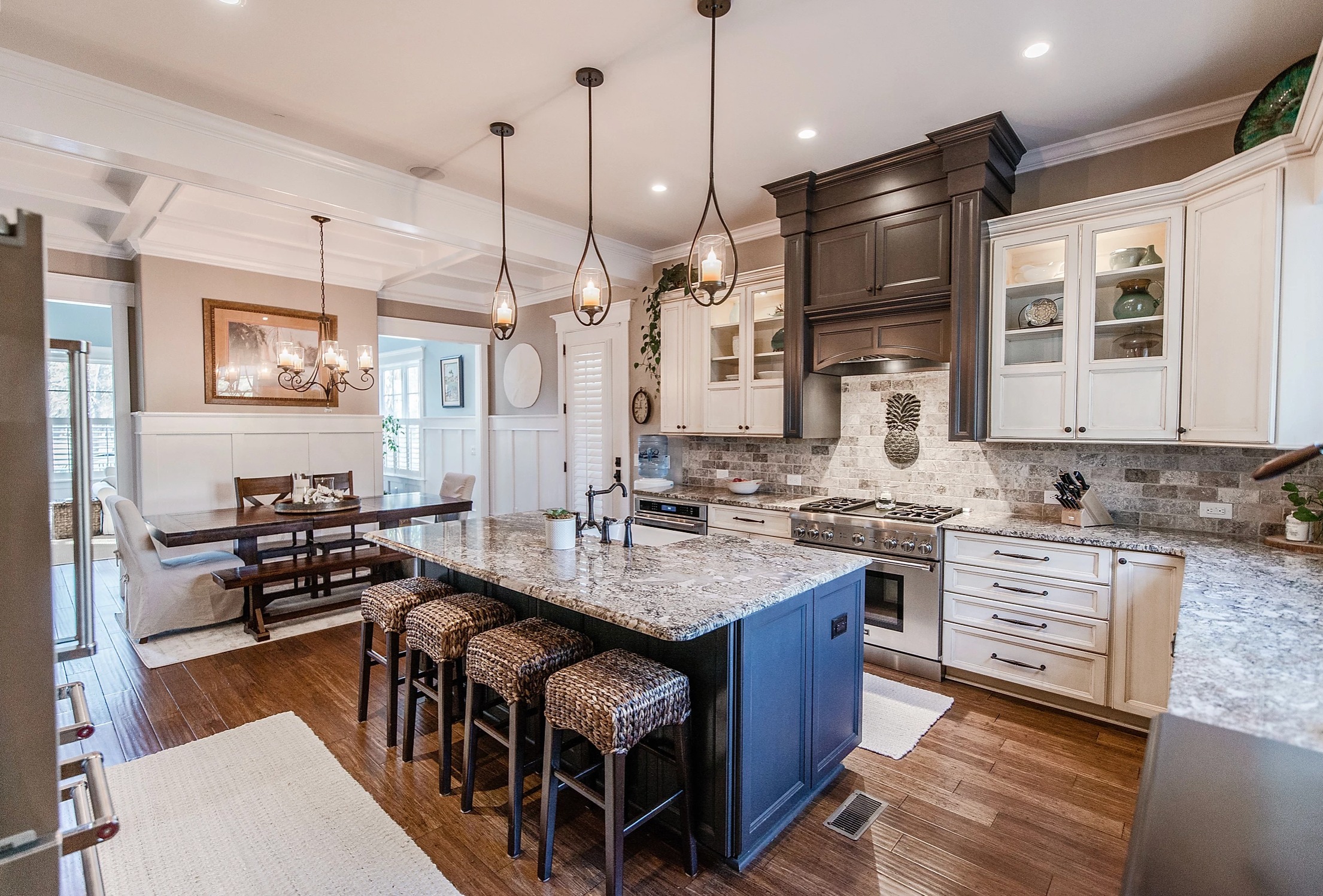 Elegant hallway with brick ceiling, dark wood floor, and white shiplap walls, leading to a glass front door. Designed by a home builder.